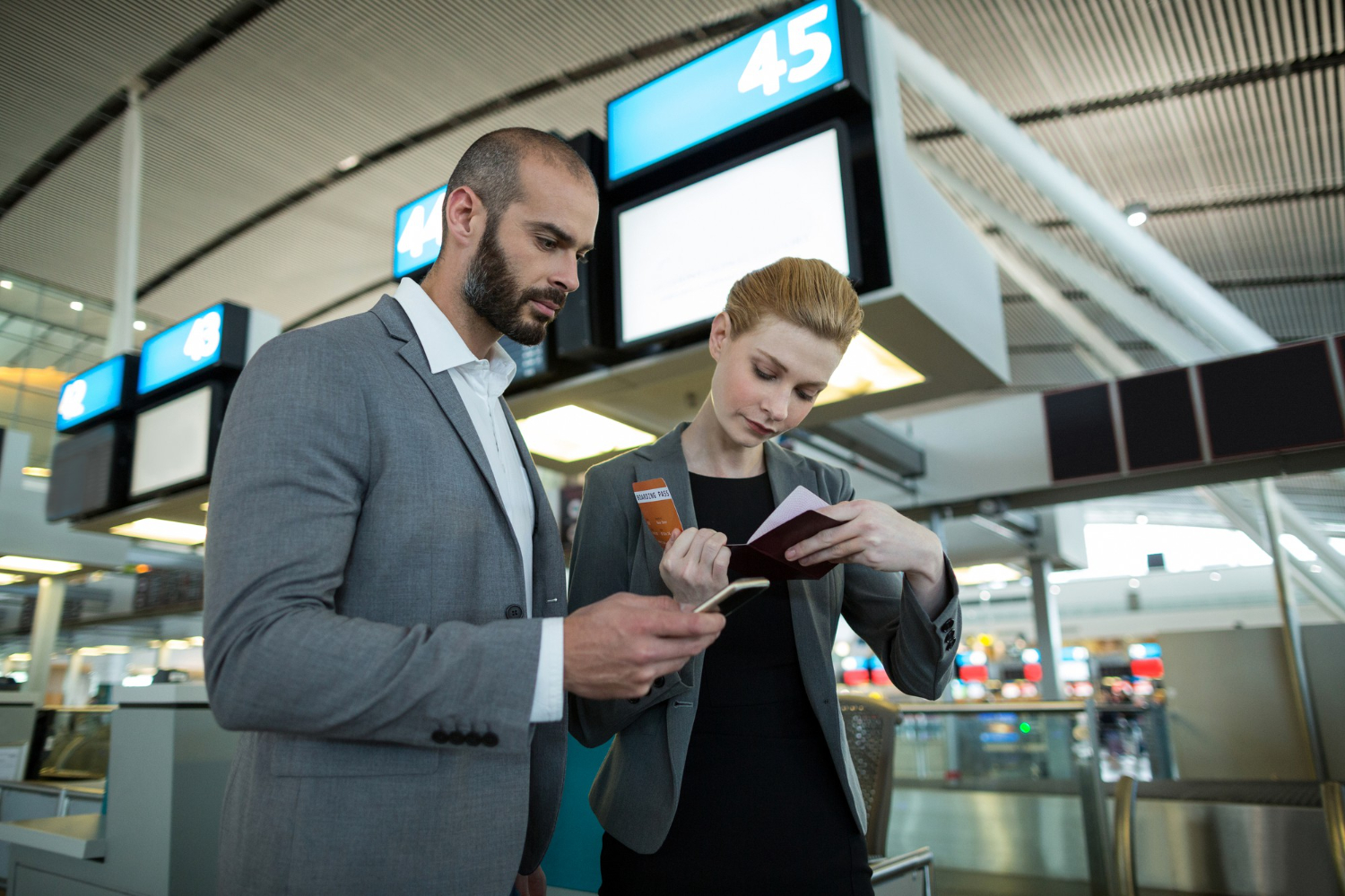 business-people-holding-boarding-pass-using-mobile-phone